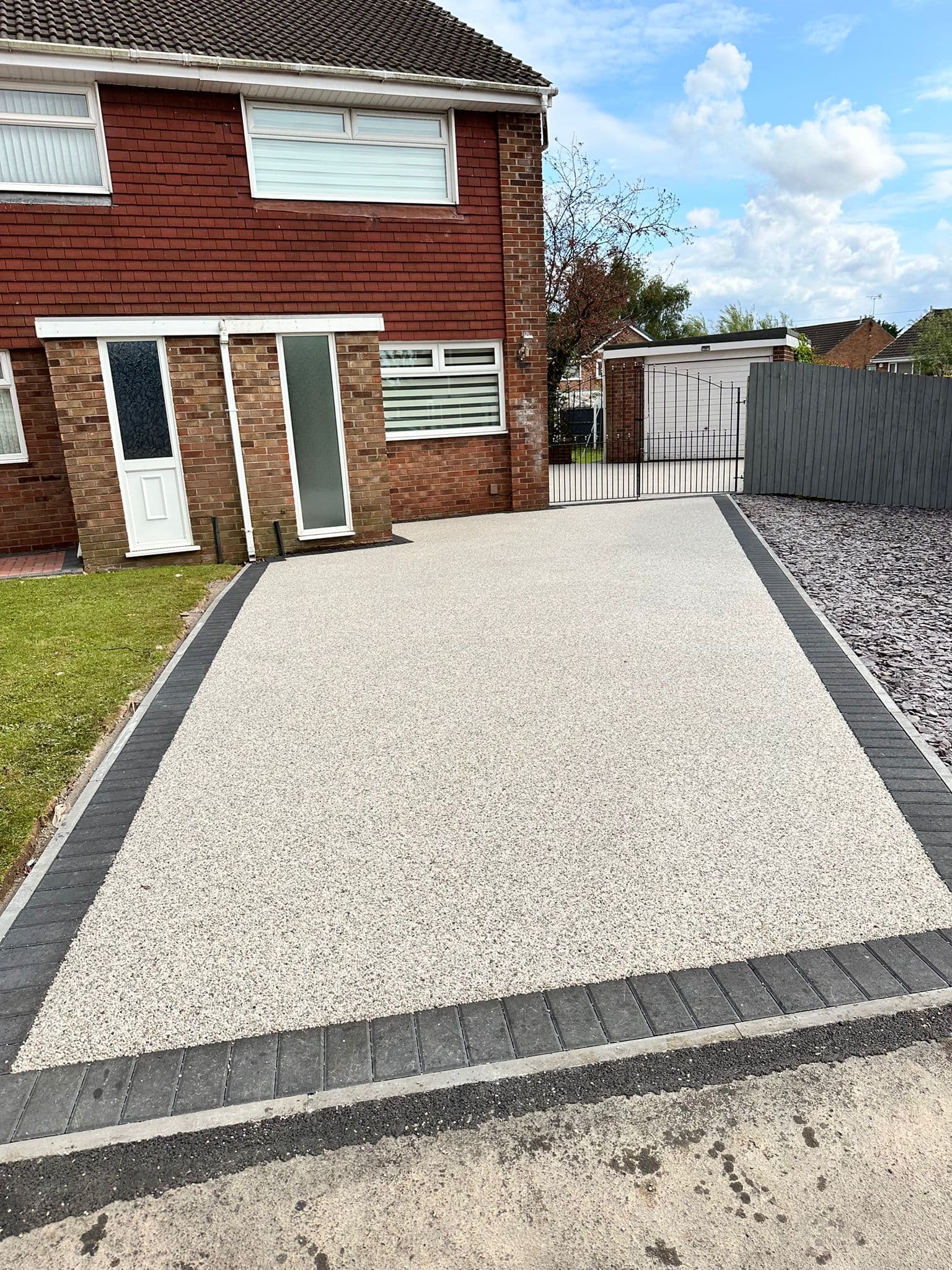 Resin bound driveway with a smooth, seamless natural stone finish