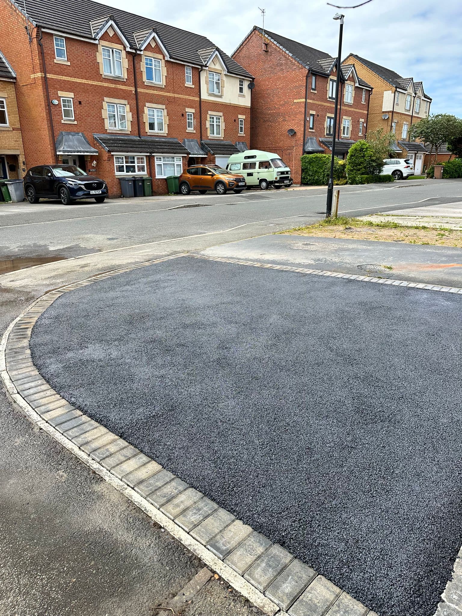 Freshly laid tarmac driveway with block paved edging