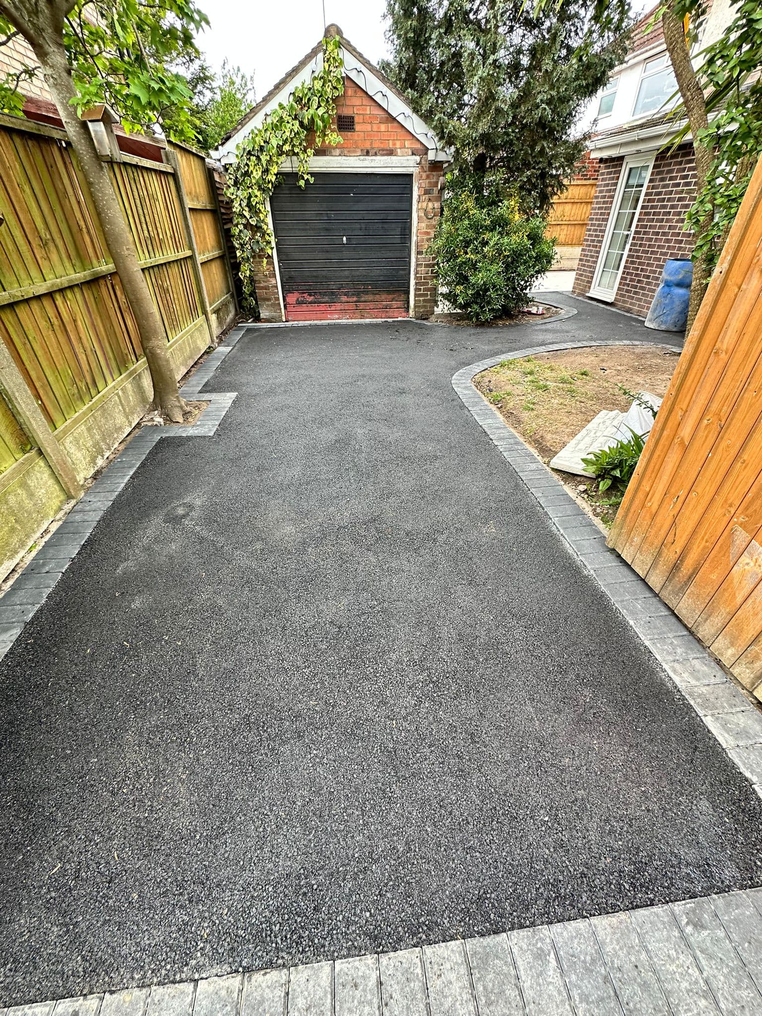 Tarmac driveway rolled to a smooth finish, meeting the road