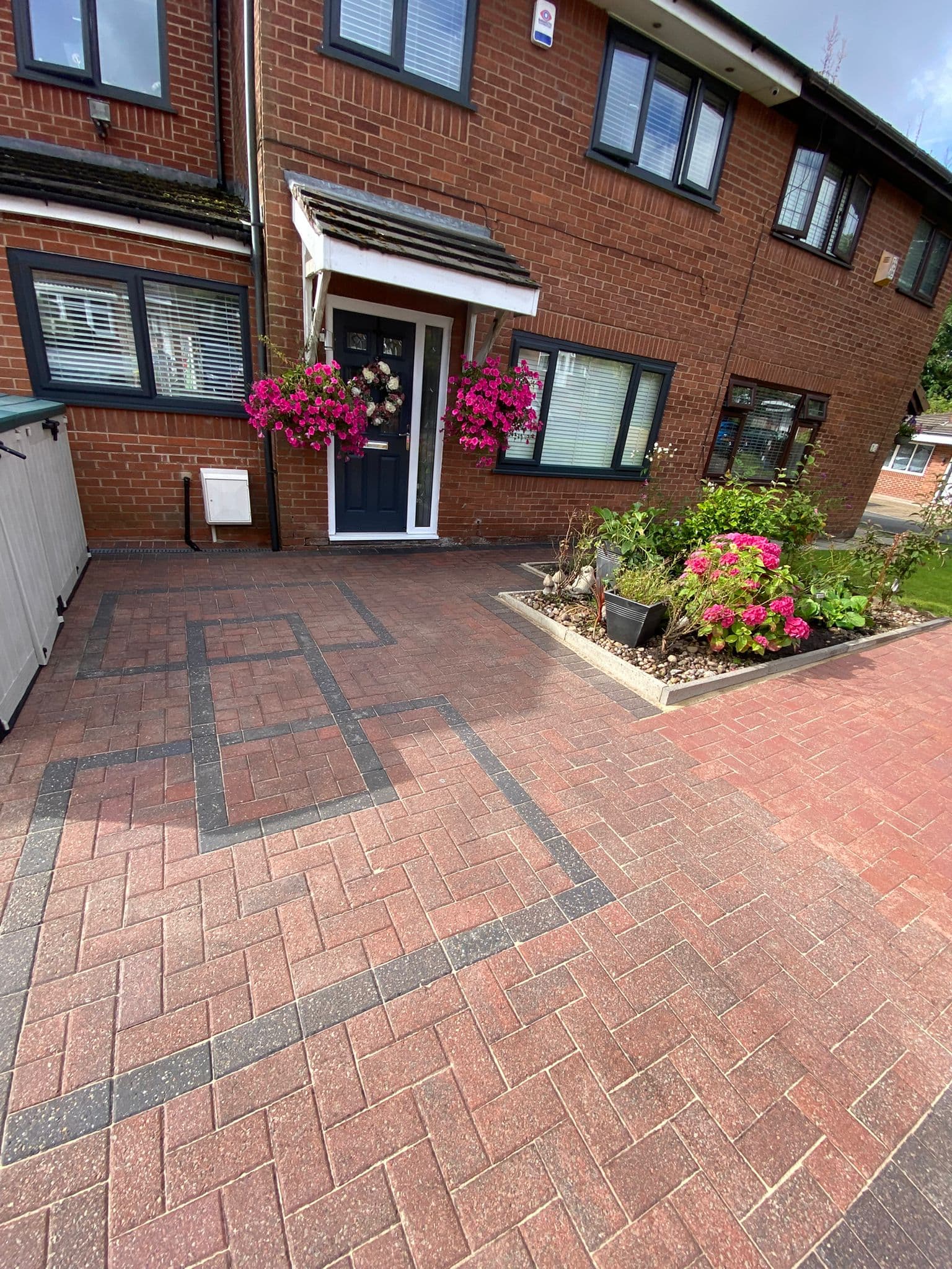Finished block paved driveway in red and charcoal, planting either side