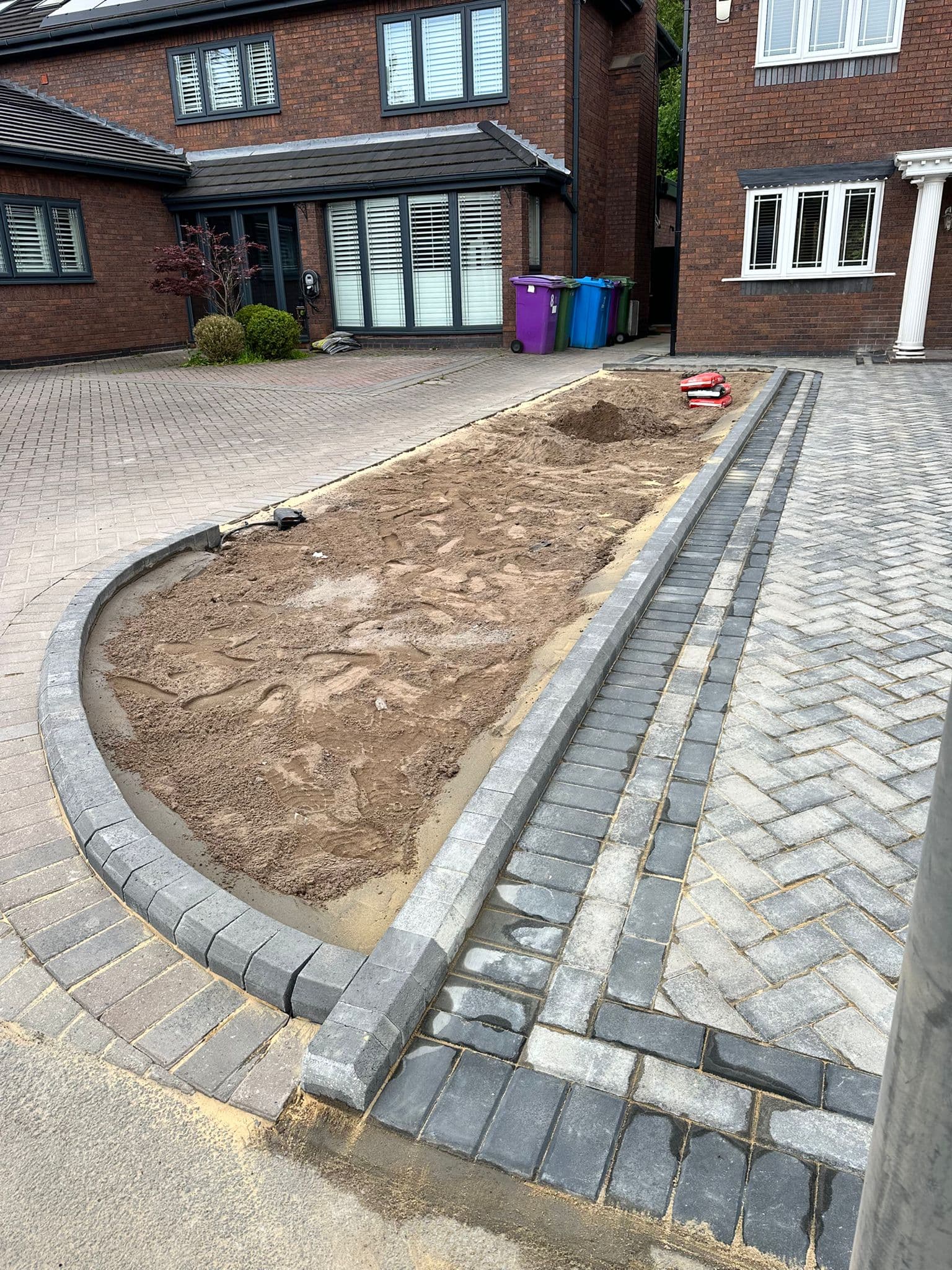 Block paving laid up to a house entrance with a stepped threshold
