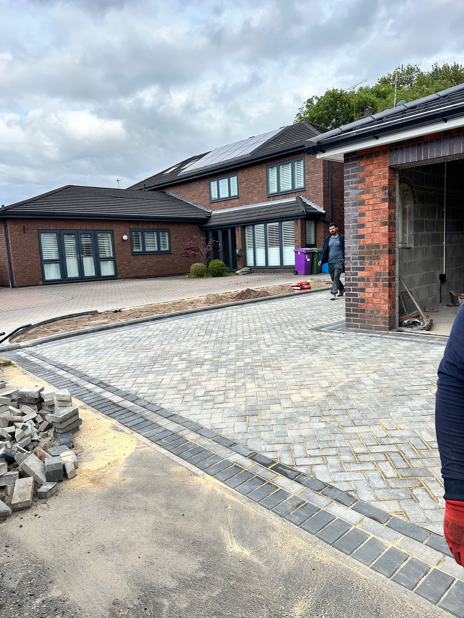Wide block paved frontage with parking for two cars