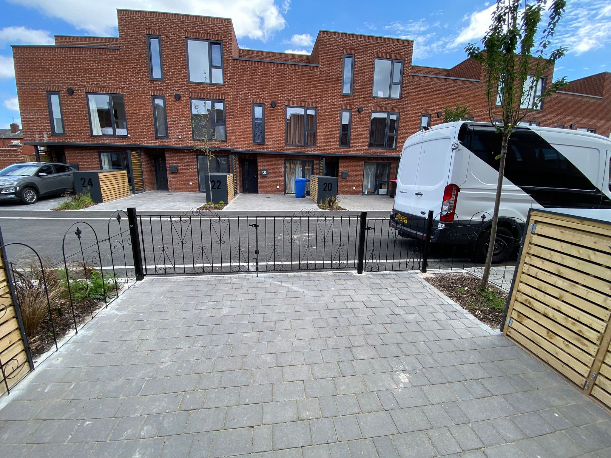Light block paved driveway finished up to the kerb