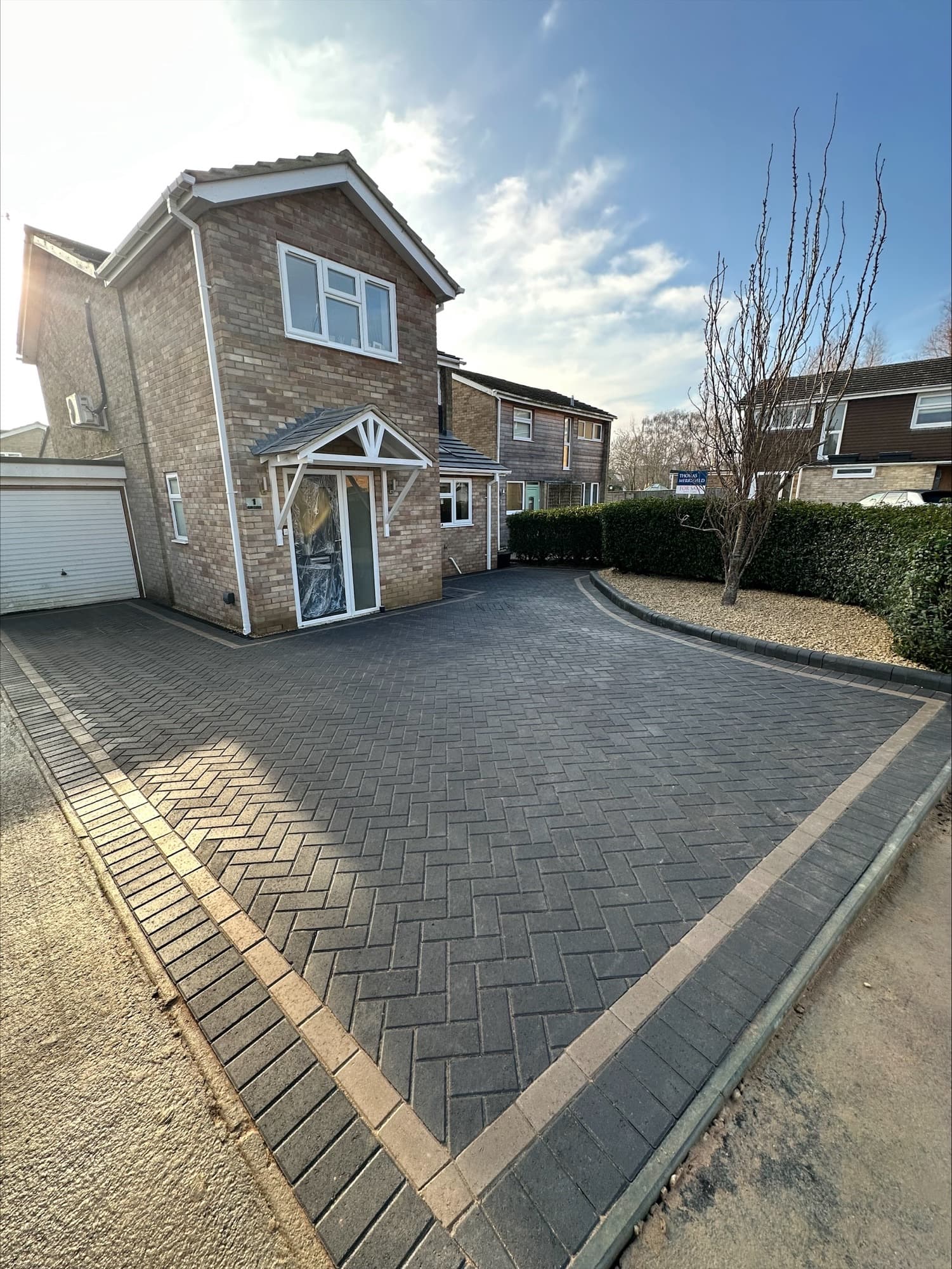 Completed charcoal block paved driveway laid in herringbone with a contrasting border